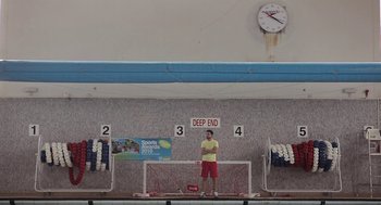 Movie still from “Weekend” (2011), directed by Andrew Haigh – A man standing in front of a soccer goal; Wide shot, Low angle