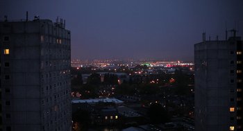 Movie still from “Weekend” (2011), directed by Andrew Haigh – A view of a city at night from a building; Extreme Wide shot, Low angle