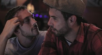 Movie still from “Weekend” (2011), directed by Andrew Haigh – A couple of men sitting next to each other; Close Up shot, Over the shoulder angle