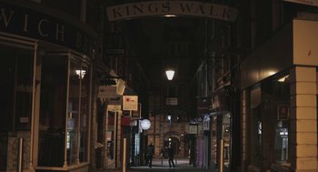 Movie still from “Weekend” (2011), directed by Andrew Haigh – People walking down an alleyway at night in the dark; Extreme Wide shot, Low angle