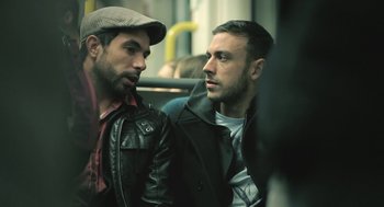 Movie still from “Weekend” (2011), directed by Andrew Haigh – Two men sitting next to each other on a bus; Close Up shot, Over the shoulder angle