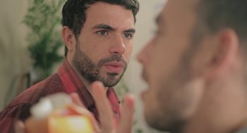 Movie still from “Weekend” (2011), directed by Andrew Haigh – A person in a mirror; Close Up shot, Over the shoulder angle