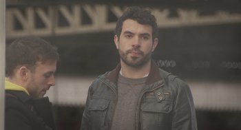 Movie still from “Weekend” (2011), directed by Andrew Haigh – A person wearing a leather jacket; Medium shot, Low angle