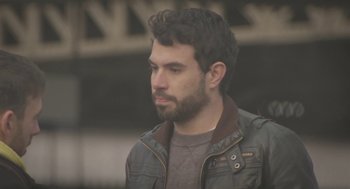 Movie still from “Weekend” (2011), directed by Andrew Haigh – A man with a beard wearing a leather jacket; Close Up shot, Low angle