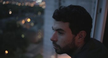 Movie still from “Weekend” (2011), directed by Andrew Haigh – A person looking at something; Close Up shot, Low angle