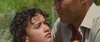 Movie still from “Whale Rider” (2002), directed by Niki Caro – A man and a woman face to face in a park; Close Up shot, Over the shoulder angle