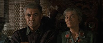 Movie still from “Whale Rider” (2002), directed by Niki Caro – An older man sitting next to an older woman; Close Up shot, Over the shoulder angle