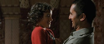 Movie still from “Whale Rider” (2002), directed by Niki Caro – A man and a woman smiling at each other; Close Up shot, Over the shoulder angle