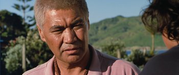 Movie still from “Whale Rider” (2002), directed by Niki Caro – A person wearing a pink shirt; Close Up shot, Low angle