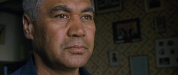 Movie still from “Whale Rider” (2002), directed by Niki Caro – A man's face in front of a wall; Close Up shot, High angle