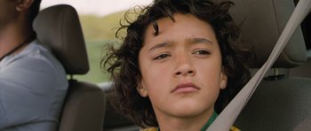 Movie still from “Whale Rider” (2002), directed by Niki Caro – A person with curly black hair; Close Up shot, Low angle