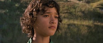 Movie still from “Whale Rider” (2002), directed by Niki Caro – A person with curly brown hair; Close Up shot, Low angle