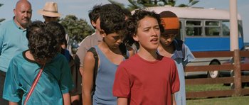 Movie still from “Whale Rider” (2002), directed by Niki Caro – A group of young people standing next to each other; Medium shot, Low angle