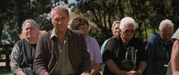 Movie still from “Whale Rider” (2002), directed by Niki Caro – A group of older people sitting in a park; Medium shot, Over the shoulder angle