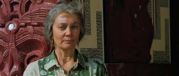 Movie still from “Whale Rider” (2002), directed by Niki Caro – An older woman wearing a green and white shirt; Close Up shot, Low angle