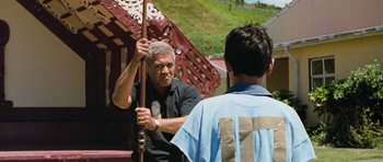 Movie still from “Whale Rider” (2002), directed by Niki Caro – An older man holding onto a stick while a young man looks on; Medium shot, Over the shoulder angle