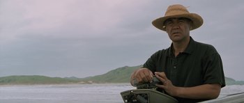 Movie still from “Whale Rider” (2002), directed by Niki Caro – A man in a straw hat is holding a radio; Medium shot, Low angle