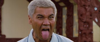 Movie still from “Whale Rider” (2002), directed by Niki Caro – An older man is sticking out his tongue; Close Up shot, Low angle
