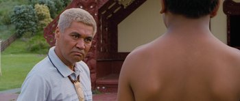 Movie still from “Whale Rider” (2002), directed by Niki Caro – An older man and a young man are looking at each other; Close Up shot, Over the shoulder angle
