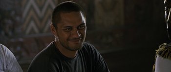 Movie still from “Whale Rider” (2002), directed by Niki Caro – A person smiling for the camera; Close Up shot, Over the shoulder angle