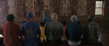 Movie still from “Whale Rider” (2002), directed by Niki Caro – A group of people sitting in front of an audience; Wide shot, High angle