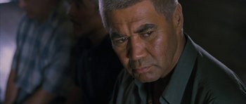Movie still from “Whale Rider” (2002), directed by Niki Caro – An older man is looking at the camera; Close Up shot, Over the shoulder angle