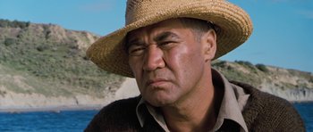 Movie still from “Whale Rider” (2002), directed by Niki Caro – A person wearing a straw hat; Close Up shot, Low angle
