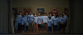 Movie still from “Whale Rider” (2002), directed by Niki Caro – A group of children standing on a stage; Wide shot, High angle