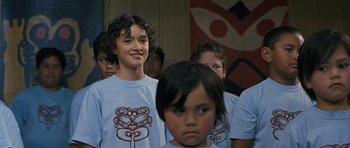 Movie still from “Whale Rider” (2002), directed by Niki Caro – A group of young people standing in front of a painting; Close Up shot, Over the shoulder angle