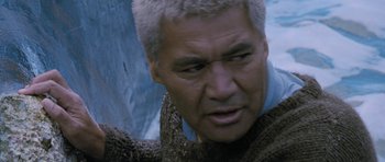 Movie still from “Whale Rider” (2002), directed by Niki Caro – An older man with grey hair looking at the camera; Close Up shot, Over the shoulder angle