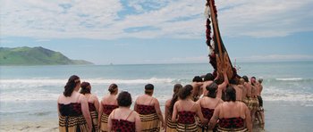 Movie still from “Whale Rider” (2002), directed by Niki Caro – A group of women standing next to each other on the beach; Extreme Wide shot, High angle