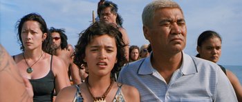Movie still from “Whale Rider” (2002), directed by Niki Caro – A young girl and an older man in front of a group of onlookers; Close Up shot, Low angle