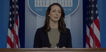 Movie still from “House of Cards” (2013), created by Beau Willimon – A woman standing at a podium in front of the white house; Close Up shot, Low angle