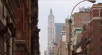Movie still from “What About Bob?” (1991), directed by Frank Oz – A view of a tall skyscraper in a city; Extreme Wide shot, High angle