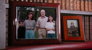 Movie still from “What About Bob?” (1991), directed by Frank Oz – A picture of a family is displayed on a table; Extreme Close Up shot, High angle