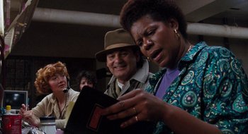 Movie still from “What About Bob?” (1991), directed by Frank Oz – A man and a woman looking at a book; Close Up shot, Over the shoulder angle
