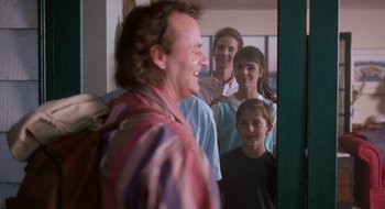 Movie still from “What About Bob?” (1991), directed by Frank Oz – A group of people standing in front of a mirror; Medium shot, Over the shoulder angle