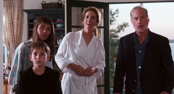 Movie still from “What About Bob?” (1991), directed by Frank Oz – A group of people standing in front of a door; Medium shot, Over the shoulder angle