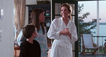 Movie still from “What About Bob?” (1991), directed by Frank Oz – A group of people standing in a living room; Medium shot, Over the shoulder angle