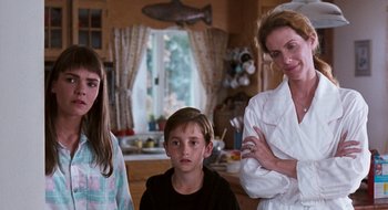 Movie still from “What About Bob?” (1991), directed by Frank Oz – A woman and two young children in a kitchen; Medium shot, Low angle