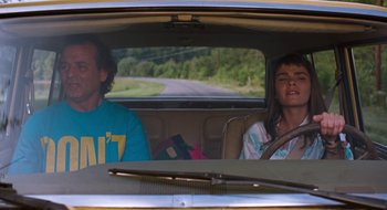 Movie still from “What About Bob?” (1991), directed by Frank Oz – A man and a woman sitting in the back of a car; Medium shot, Low angle