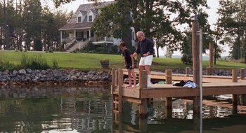 Movie still from “What About Bob?” (1991), directed by Frank Oz – A man and a woman fishing on a dock; Wide shot, High angle