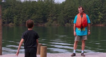 Movie still from “What About Bob?” (1991), directed by Frank Oz – A man and a boy standing on a dock by the water; Wide shot, Over the shoulder angle