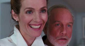 Movie still from “What About Bob?” (1991), directed by Frank Oz – A person smiling with another person in the background; Close Up shot, Over the shoulder angle