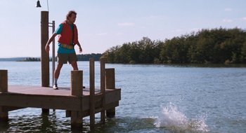 Movie still from “What About Bob?” (1991), directed by Frank Oz – A man standing on a dock in the water; Extreme Wide shot, Over the shoulder angle
