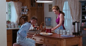 Movie still from “What About Bob?” (1991), directed by Frank Oz – Two women in a kitchen preparing a meal together; Medium shot, High angle