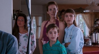 Movie still from “What About Bob?” (1991), directed by Frank Oz – A group of people standing in a living room; Medium shot, Over the shoulder angle