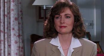 Movie still from “What About Bob?” (1991), directed by Frank Oz – A person wearing a suit and tie; Close Up shot, Over the shoulder angle