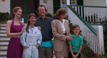 Movie still from “What About Bob?” (1991), directed by Frank Oz – A group of people standing next to each other on a porch; Medium shot, Low angle
