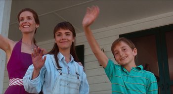 Movie still from “What About Bob?” (1991), directed by Frank Oz – A boy and a girl waving at the camera; Medium shot, Low angle